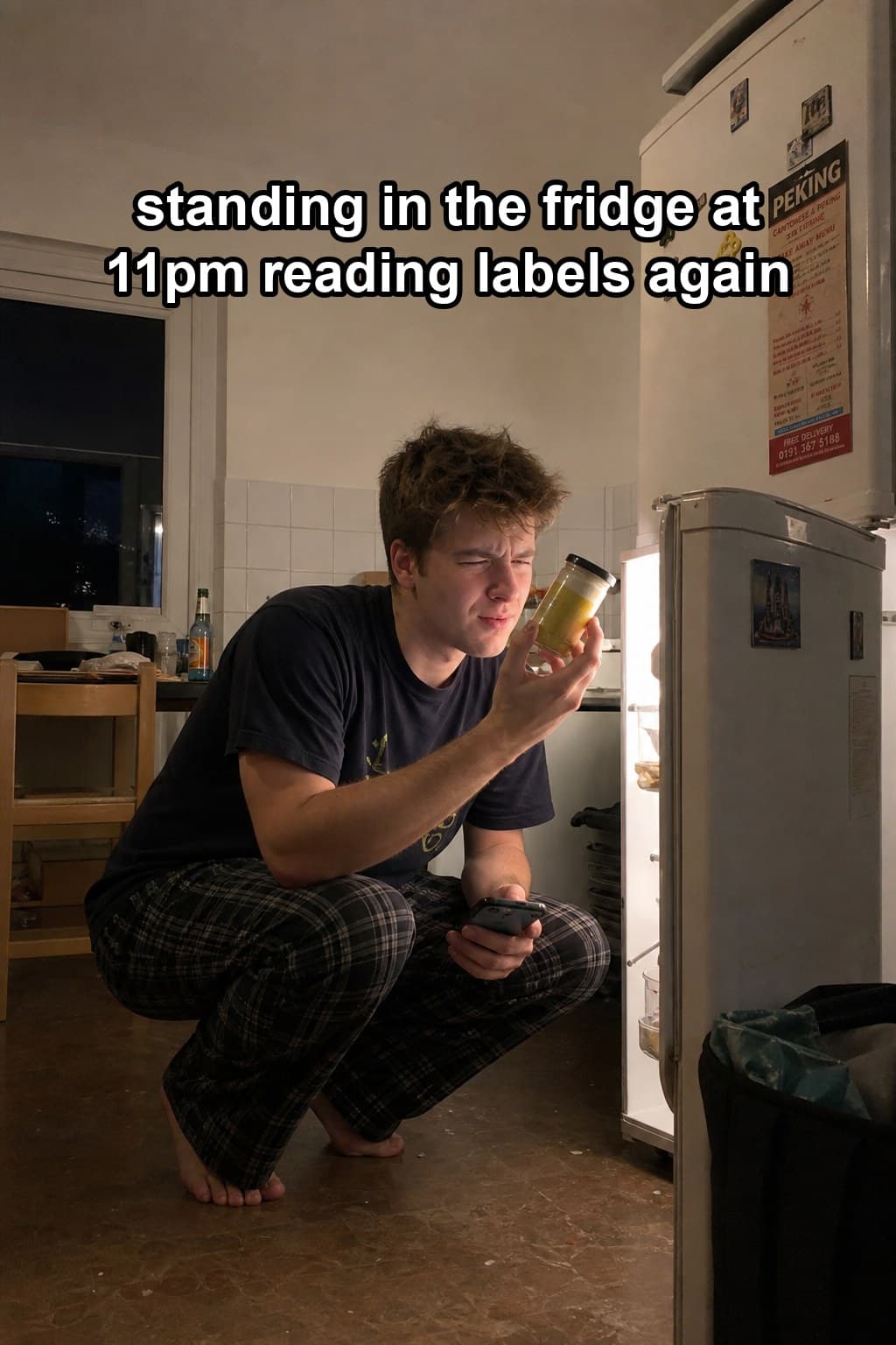 Stratos post: crouched at an open fridge at night reading a jar